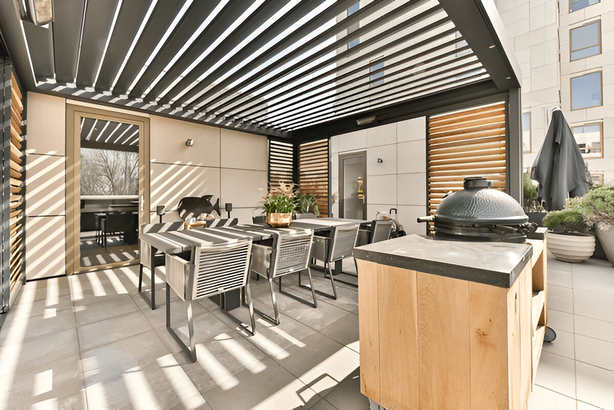 Modern outdoor dining area with pergola and grill 