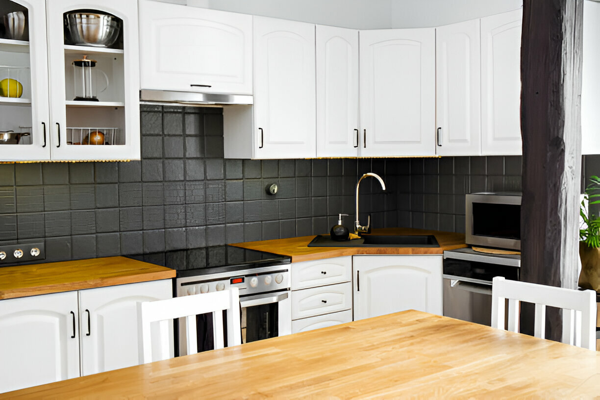 Traditional kitchen with white cabinets and wooden countertops