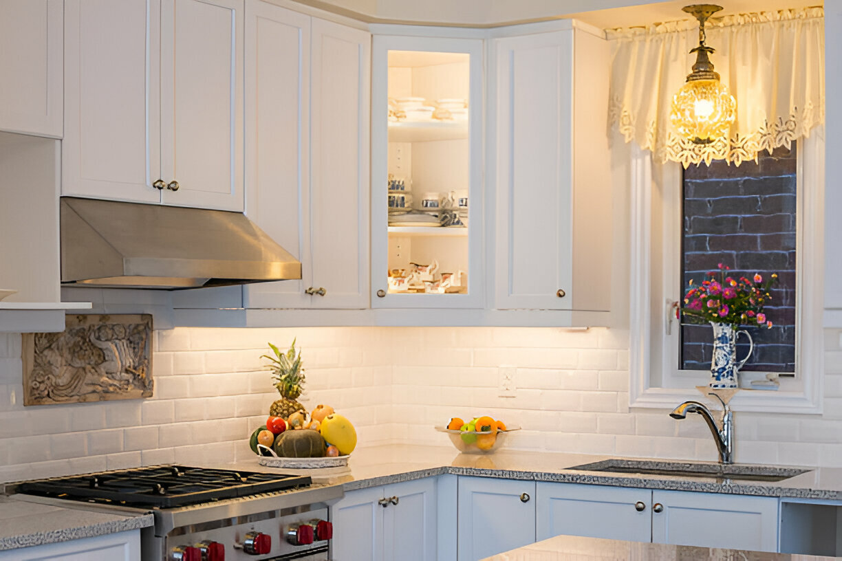 Traditional white kitchen with under-cabinet lighting and fruit decor