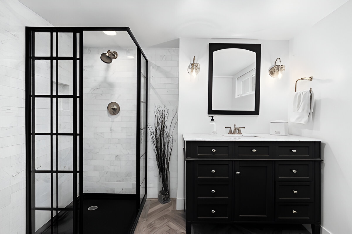 Black and white modern bathroom with framed glass shower and black vanity