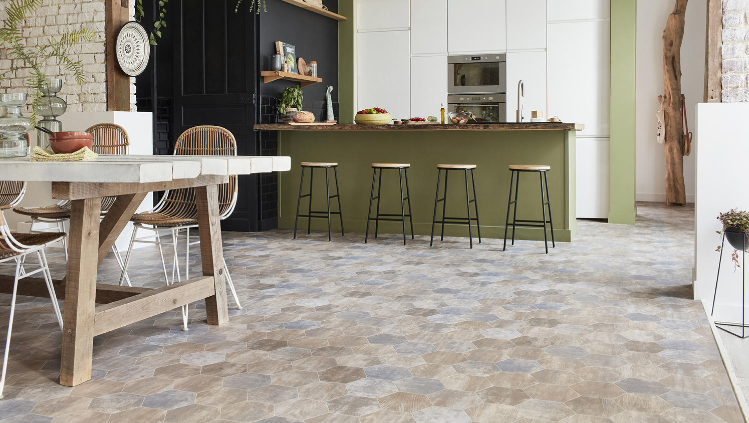 Open-concept kitchen with multi-tone hexagon vinyl flooring, green breakfast bar, and wooden dining furniture
