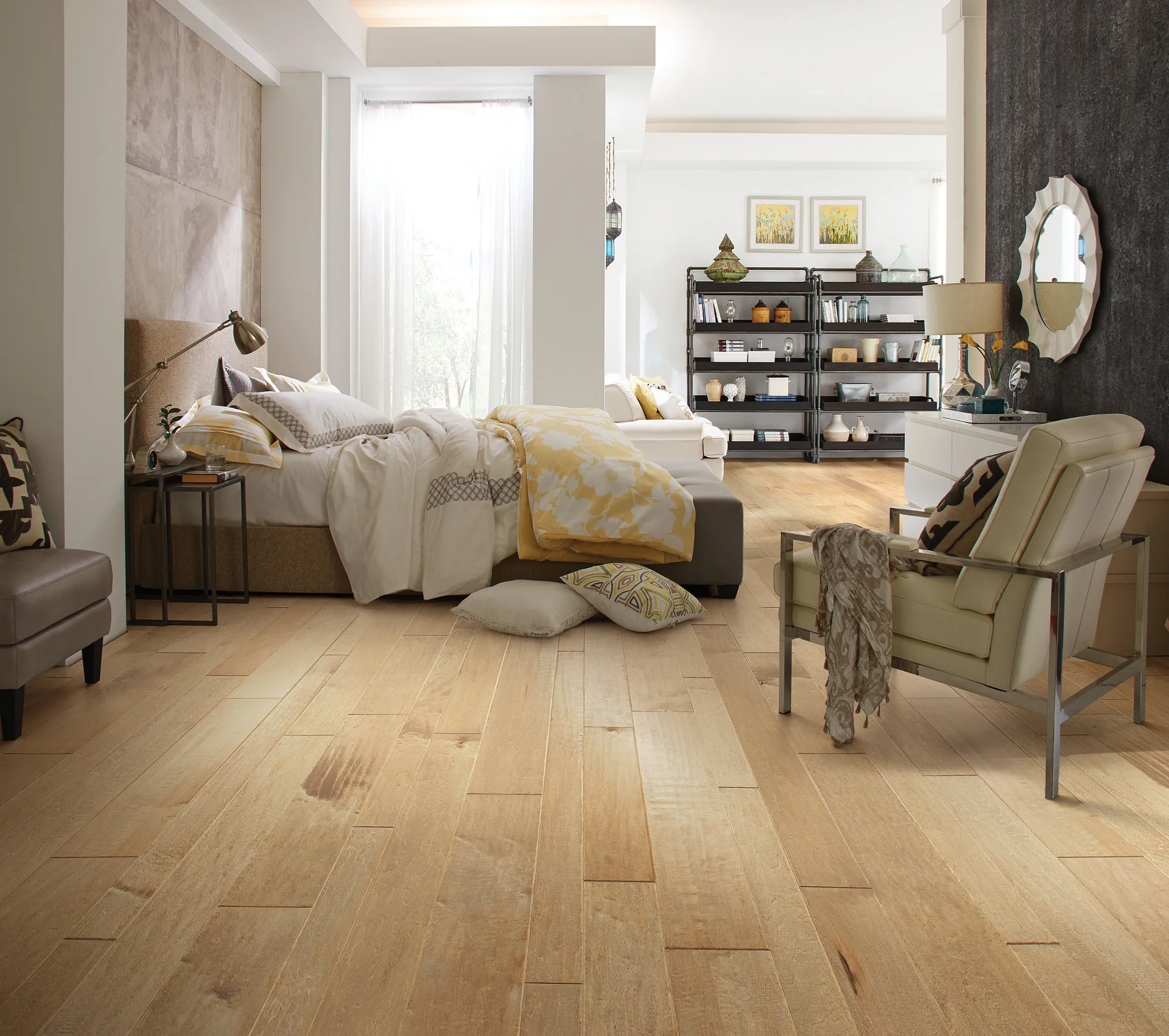 Bright bedroom with natural maple wood flooring, neutral bedding, soft pillows, and contemporary furniture