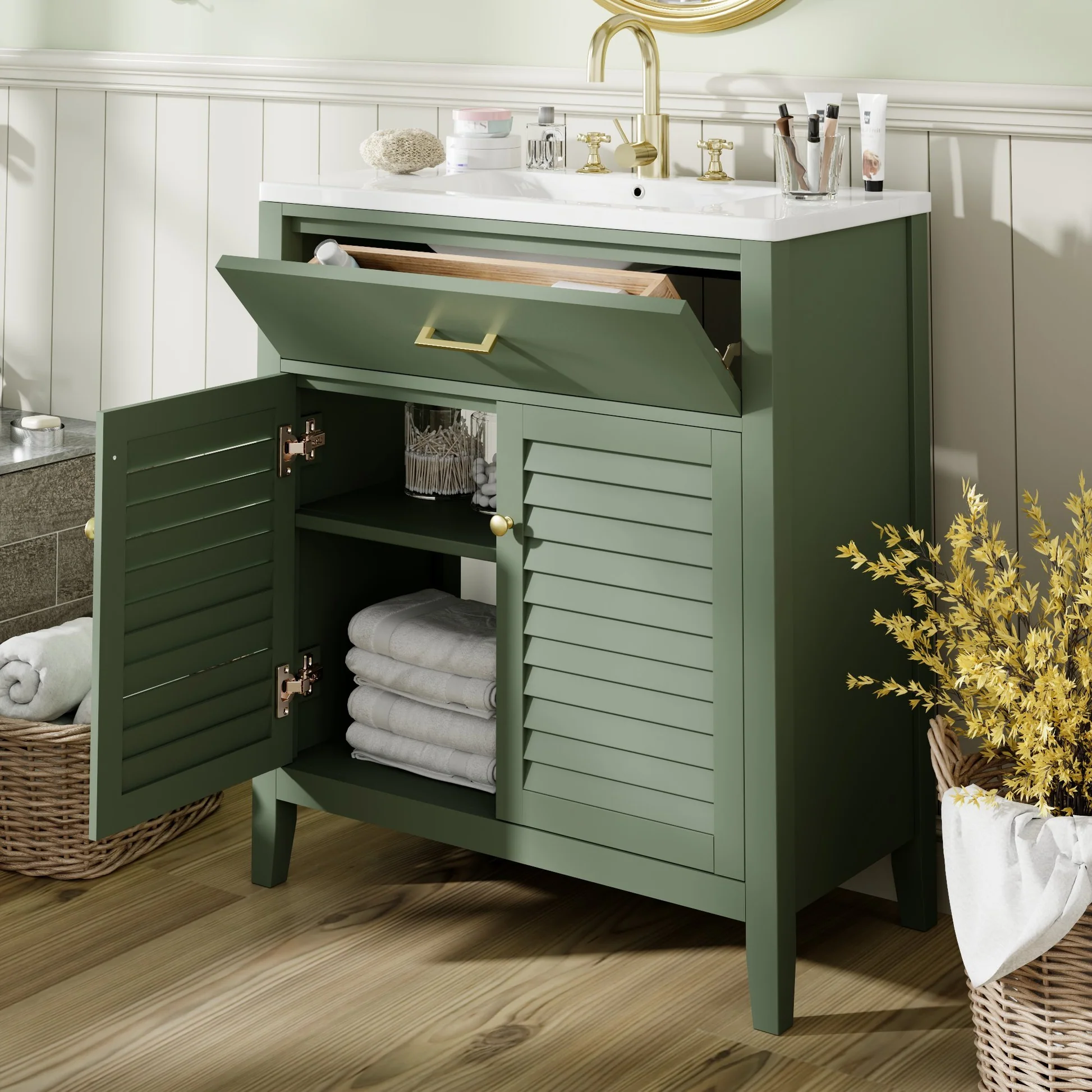 Green freestanding bathroom vanity with louvered cabinet doors, open top compartment, and gold faucet