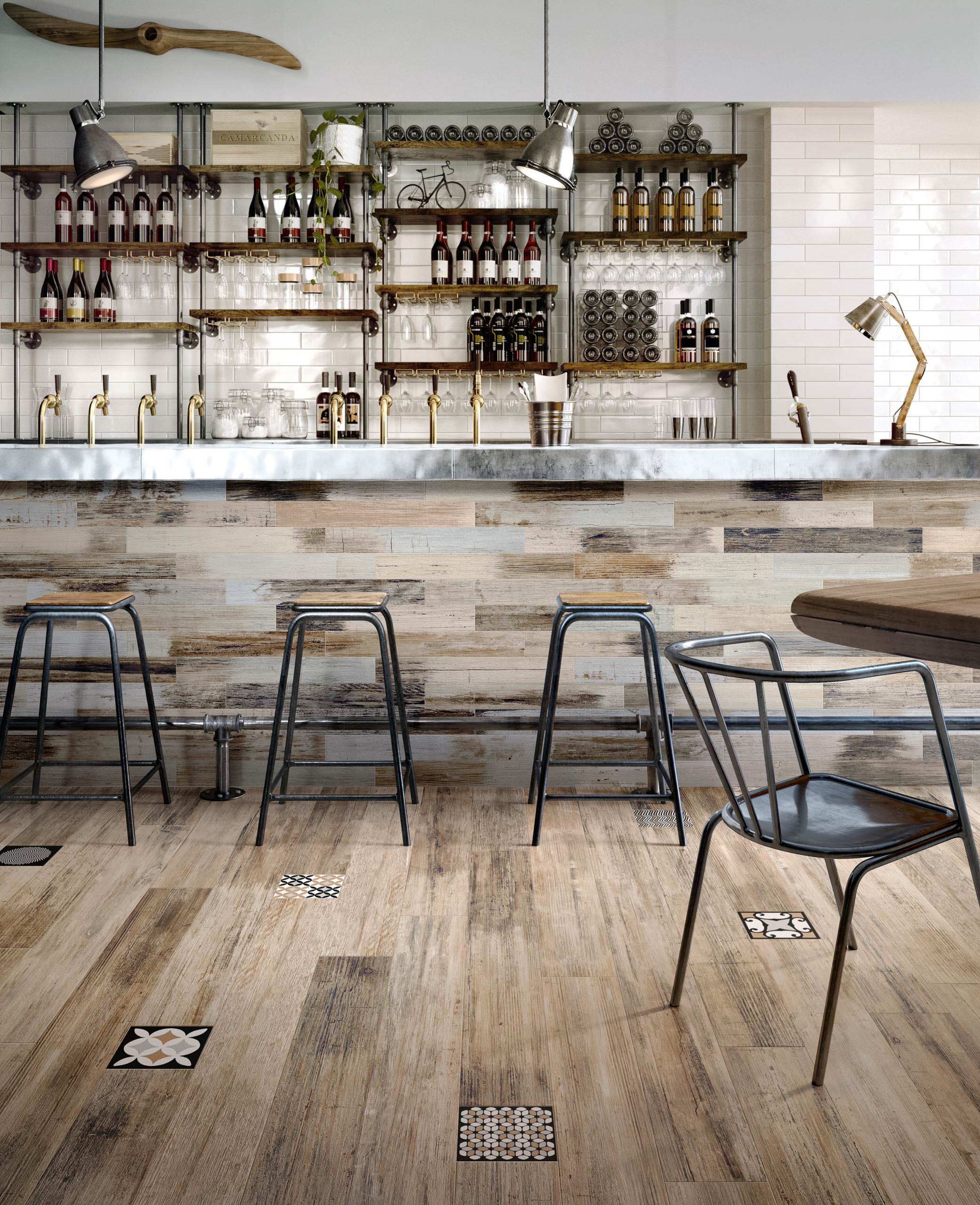 Rustic industrial bar with wooden-look floor tiles, metal stools, open shelving, and wine bottle display