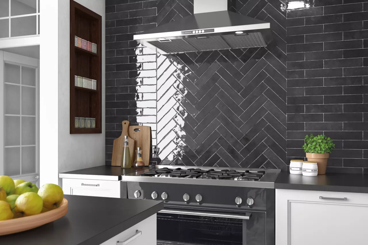 Contemporary kitchen featuring a glossy black herringbone backsplash, stainless steel range, and minimalist countertops.