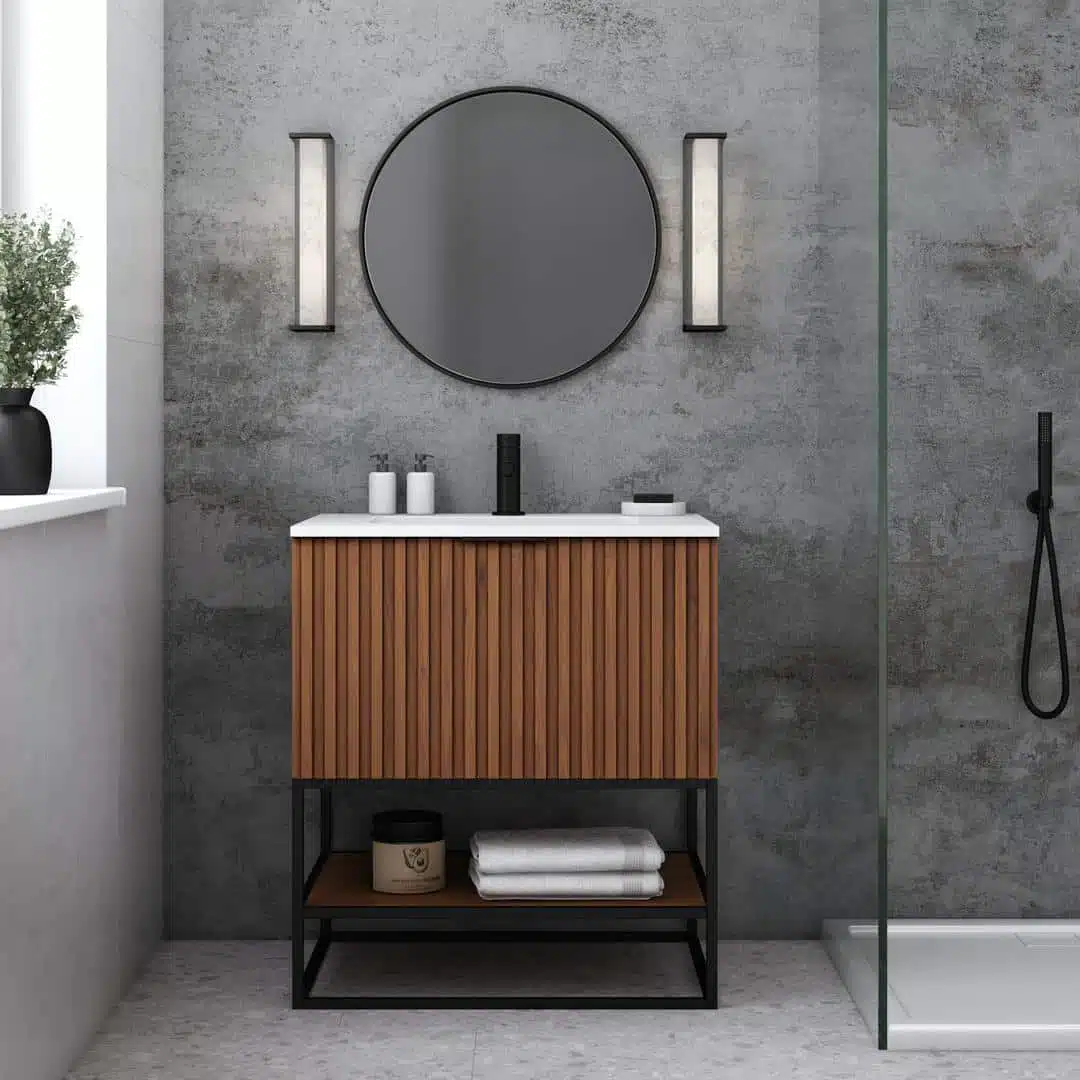 Modern bathroom featuring a slatted walnut vanity, matte black fixtures, round mirror, and concrete wall backdrop