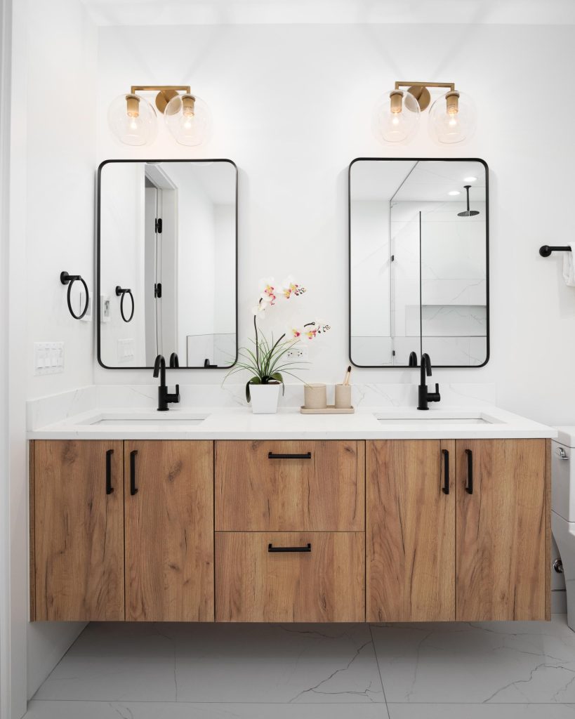 Floating natural wood bathroom vanity with double sinks, black fixtures, and rectangular mirrors