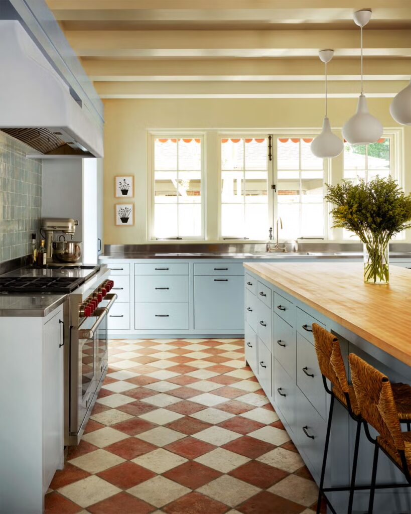 Sleek kitchen design featuring a marble island, wood-paneled walls, and integrated modern lighting.