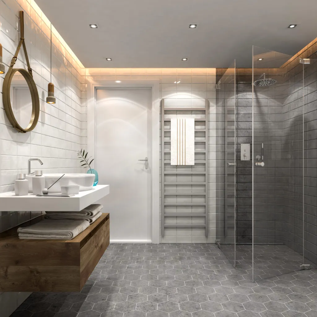 Contemporary bathroom with glass shower, wooden vanity, hexagon tile floor, and modern lighting.