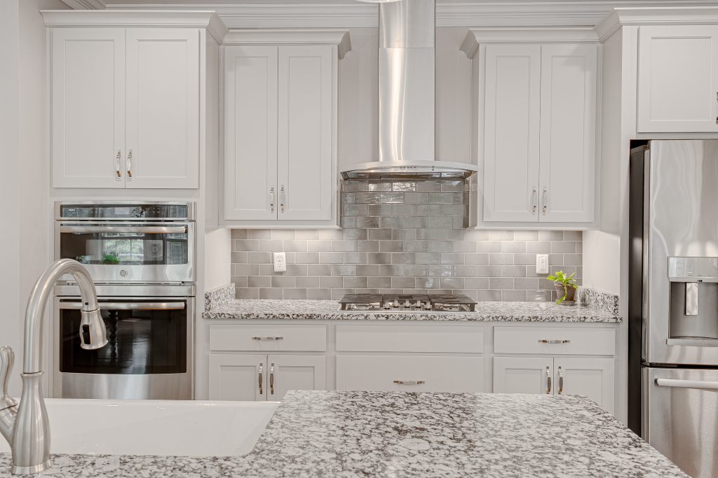 Modern kitchen with custom granite countertops and white cabinets