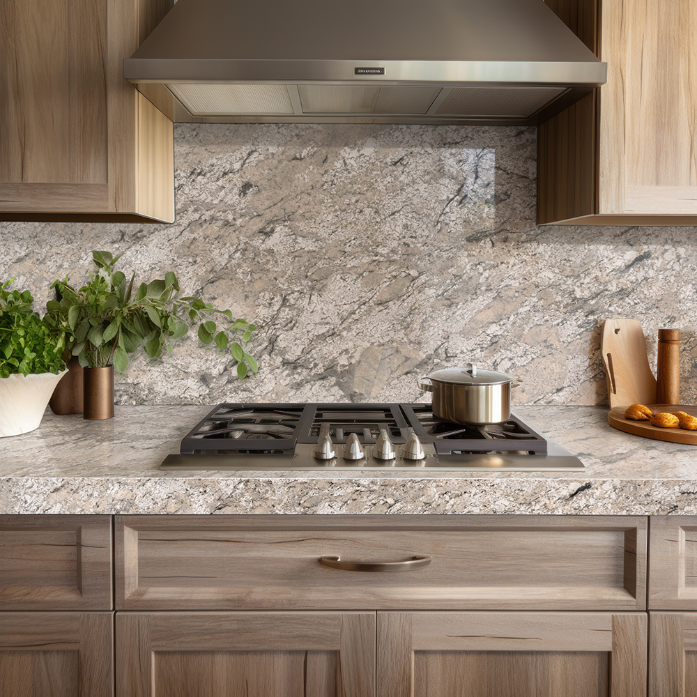 Close-up of a kitchen with Sunset Canyon granite countertops and backsplash, stainless steel cooktop, and wood cabinets.