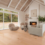 Cozy modern living room with vaulted ceiling, fireplace, and light wood flooring