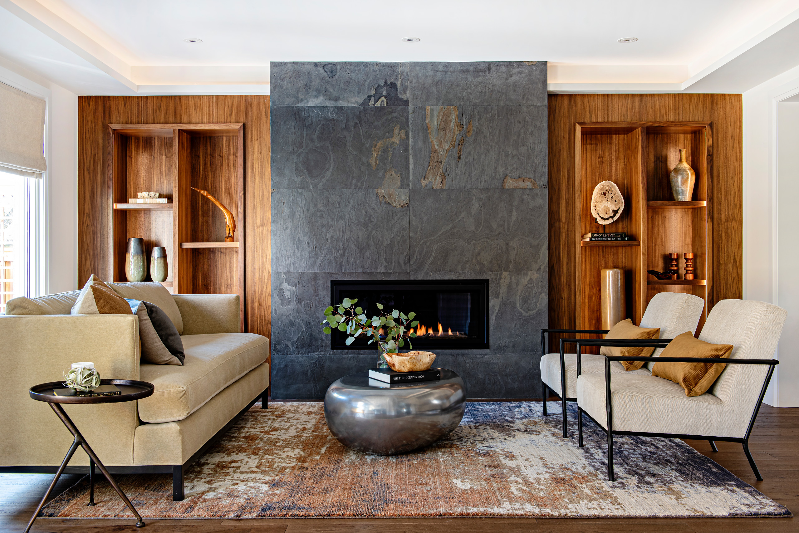 Modern living room with stone fireplace and wood built-ins