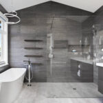 Contemporary bathroom with freestanding tub, glass shower, and modern vanity