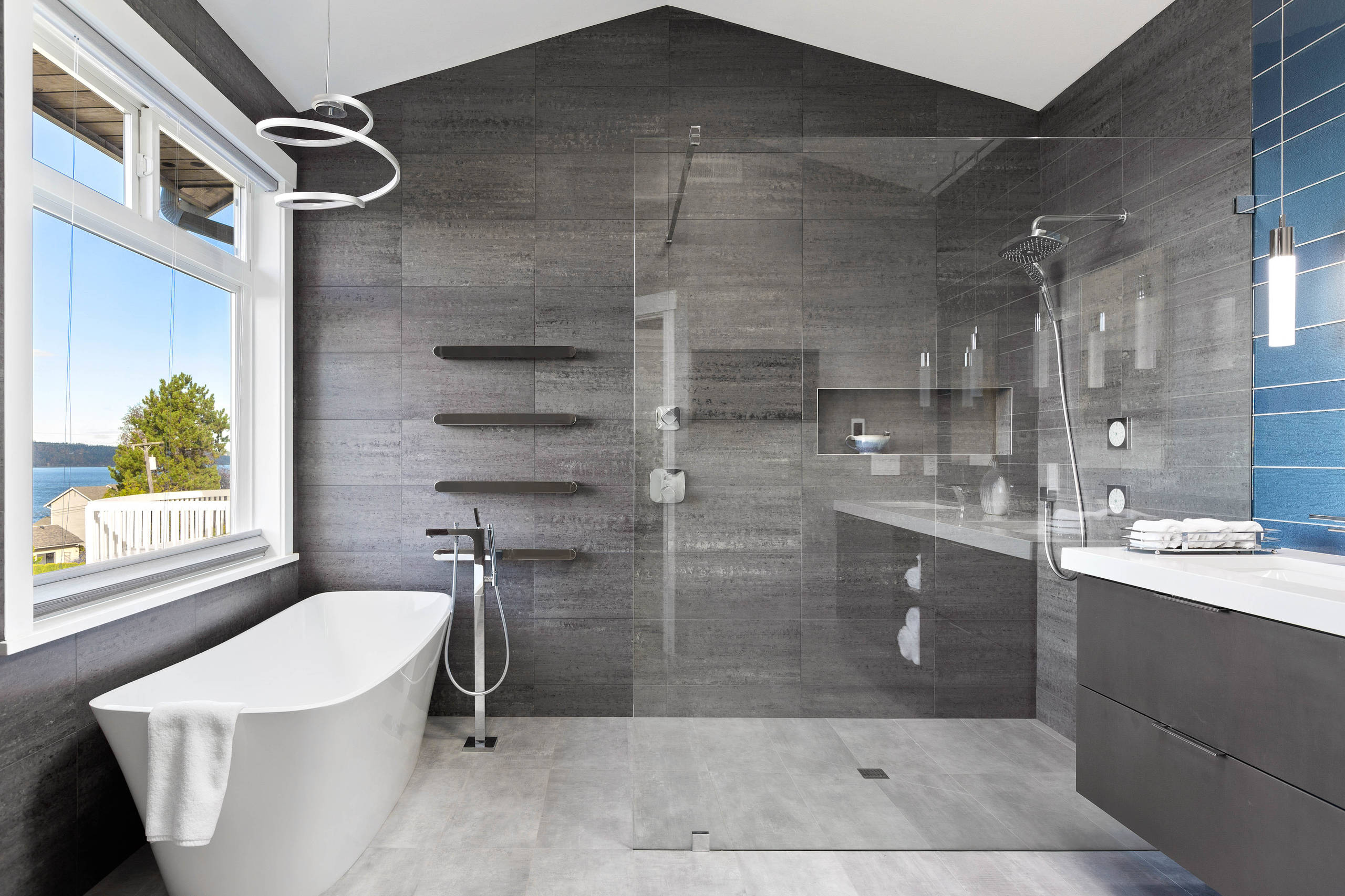 Contemporary bathroom with freestanding tub, glass shower, and modern vanity