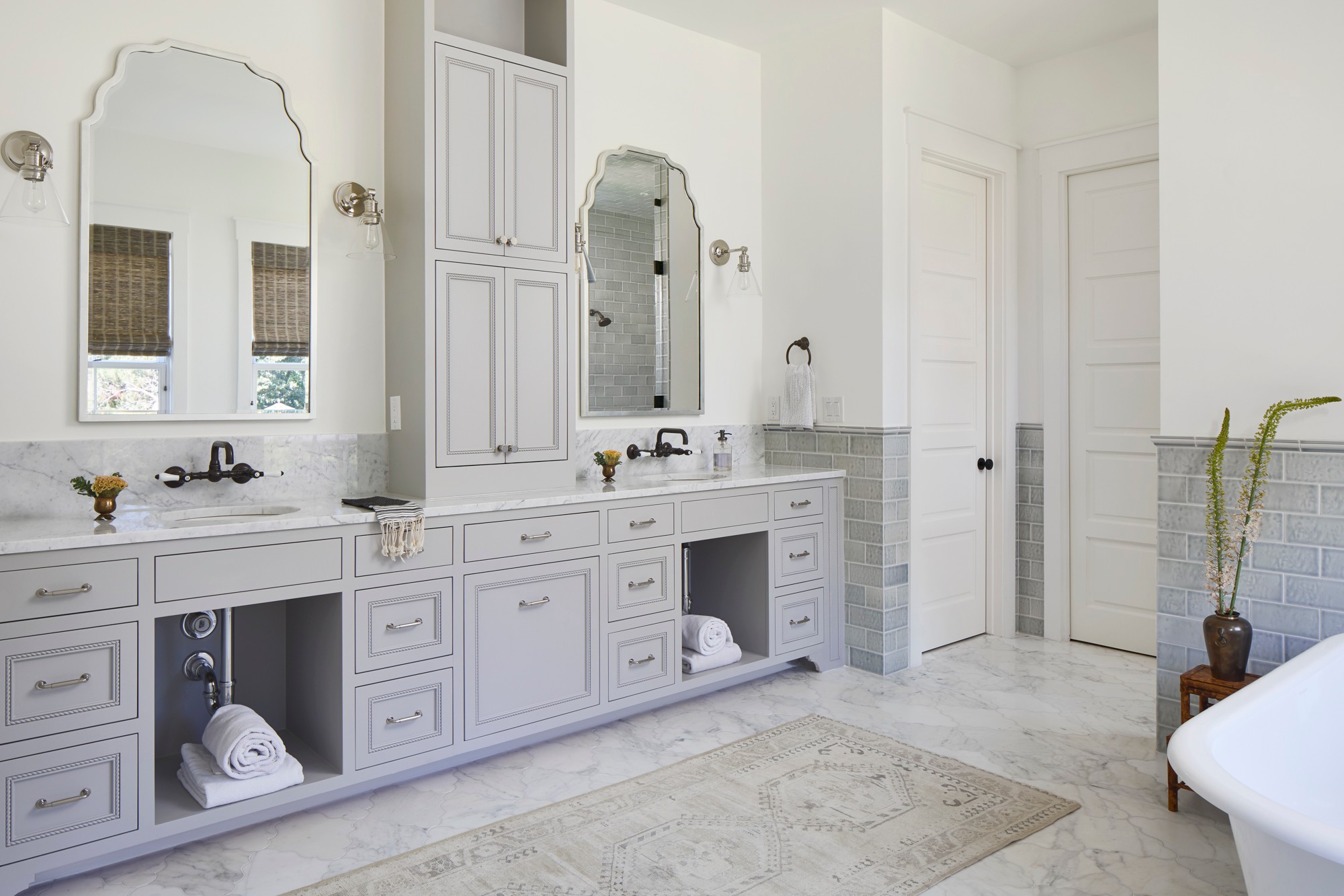 Elegant bathroom with double vanity, gray cabinets, and marble finishes
