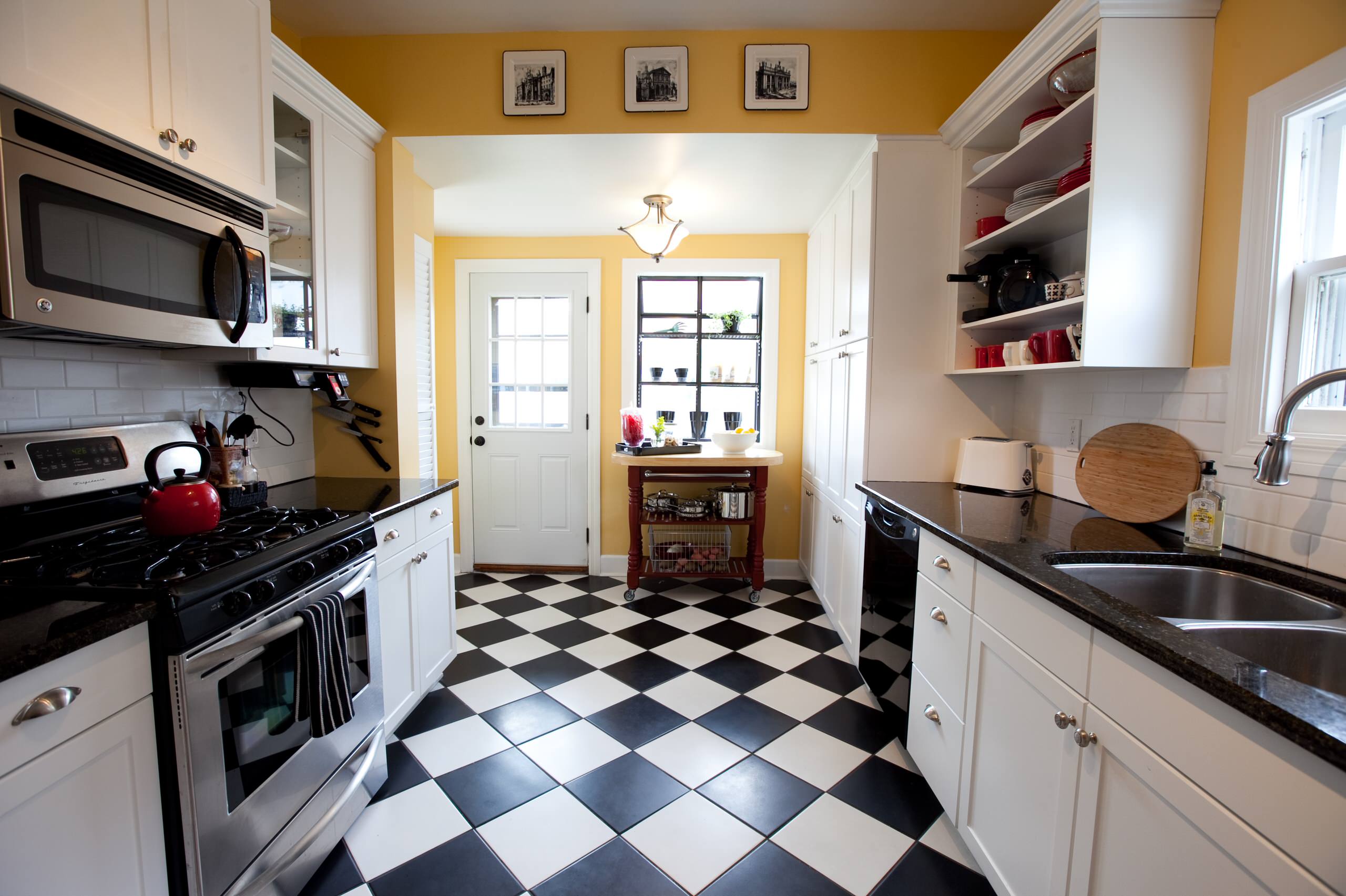 Charming kitchen with black-and-white checkered floor, yellow walls, and white cabinets