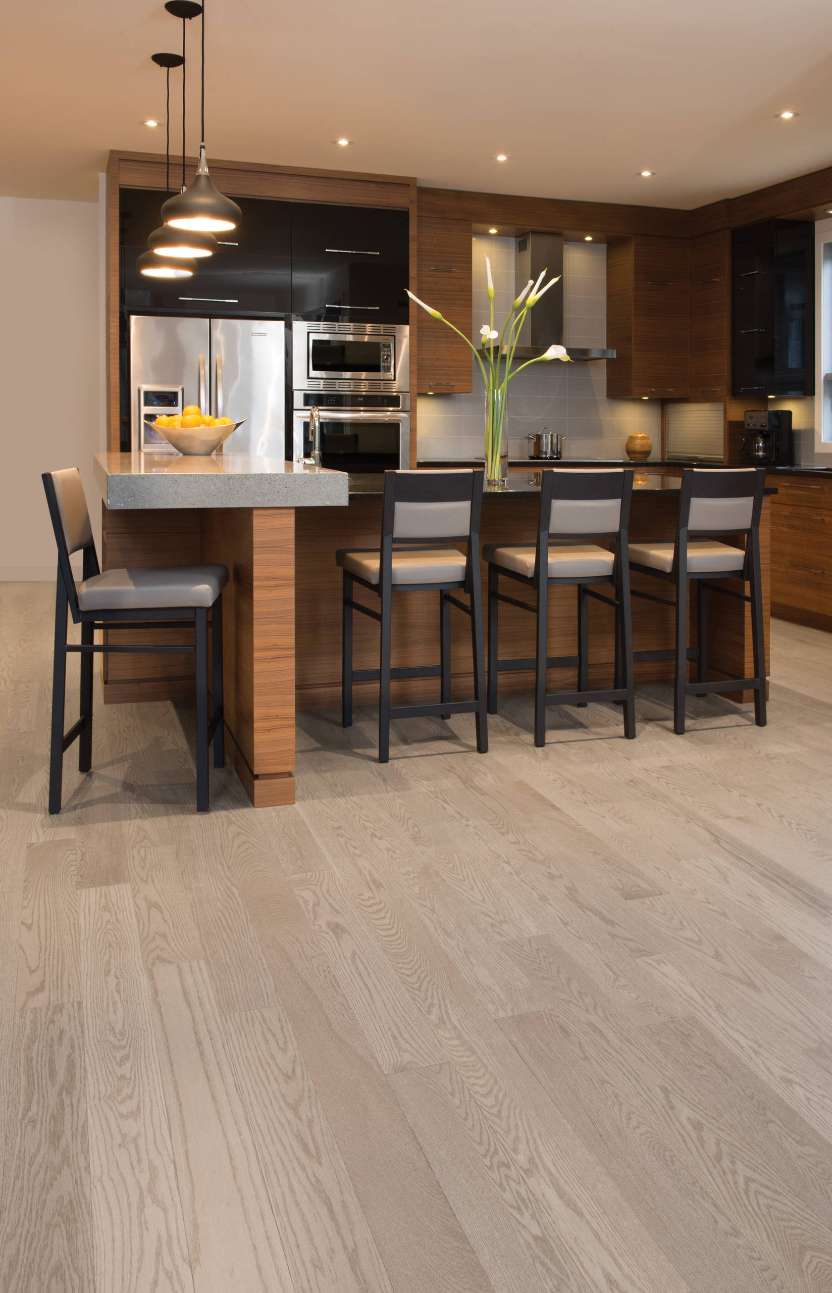 Modern kitchen with wood cabinets, island seating, and light hardwood floors